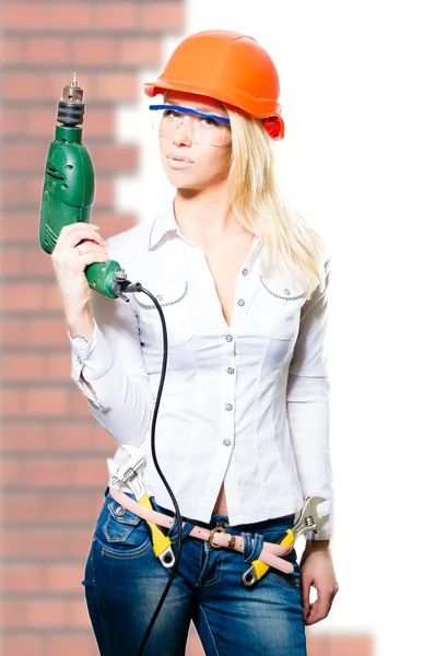 Young sexi bossy blonde lady in helmet  with drill — Stock Photo, Image