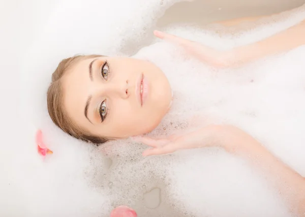 Pretty face in white fluffy foam — Stock Photo, Image