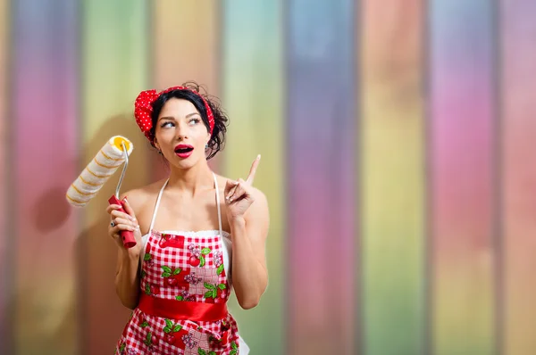 Creative pinup  woman with paint roller — Stock Photo, Image