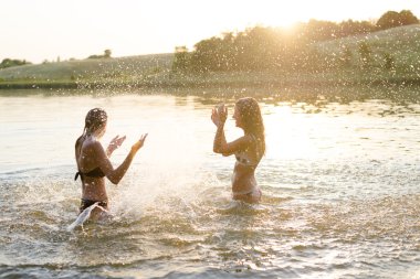 Two females having fun in lake