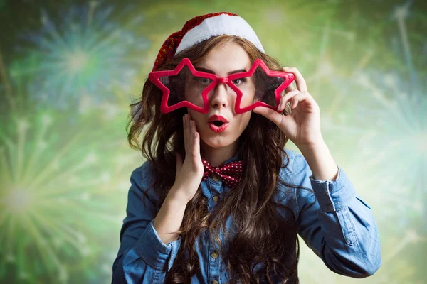 Girl in Santa hat and starshaped glasses — Stock Photo, Image