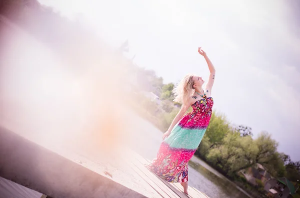 Gracious young woman dancing by lake — Stock Photo, Image