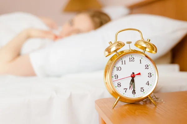 Retro alarm clock with sleeping lady — Stock Photo, Image