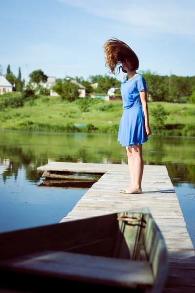 Girl flying her long hair on bridge — Zdjęcie stockowe