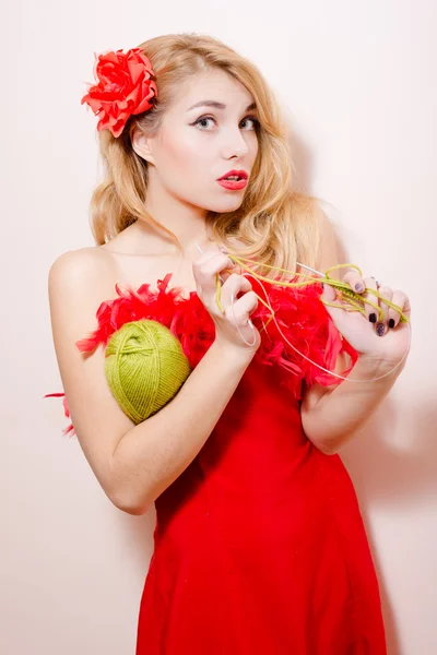 Knitting girl in red dress — Stockfoto