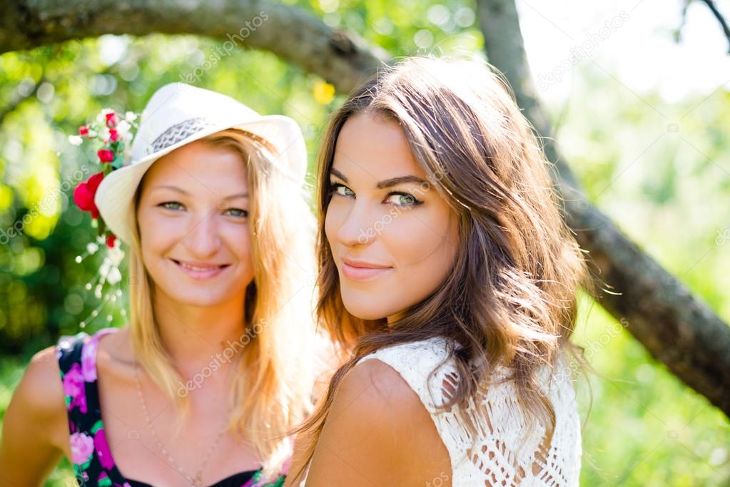 women smiling in sunny summer park