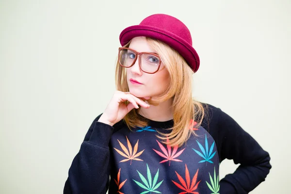 Girl in red hat touching her chin — Stock Photo, Image