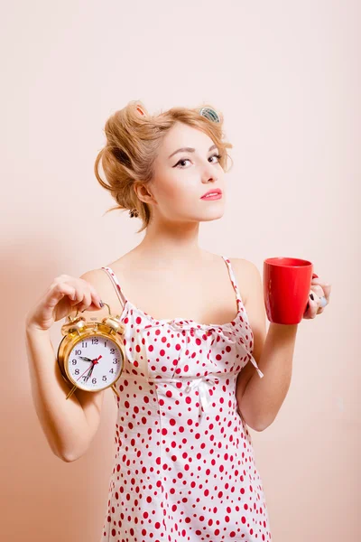 Housewife with alarm-clock and cup — Stok fotoğraf