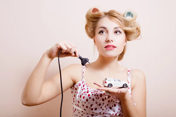 Housewife with charger for toy car — ストック写真