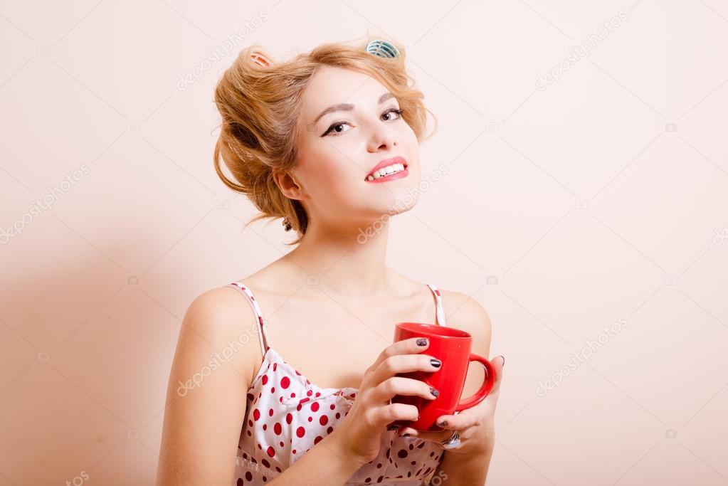 Housewife with red cup of hot drink