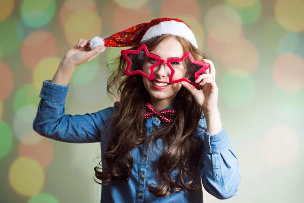 Girl in star shaped glasses and santa hat — Stock Photo, Image