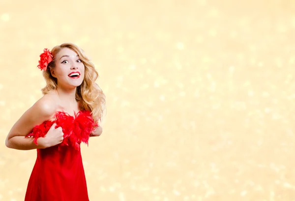 Pretty girl in red dress excited on bokeh lights background — ストック写真