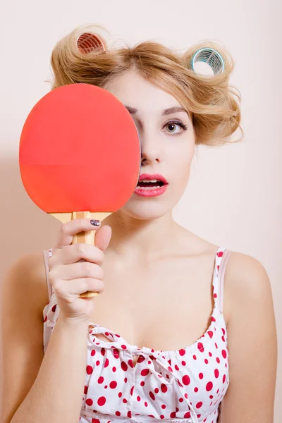 Pretty girl in dress and big curlers holding pingpong racket — ストック写真