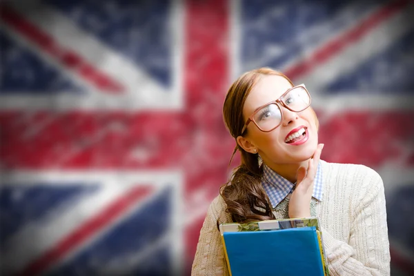 Pretty girl in glasses smiling on english Union Jack background — 图库照片