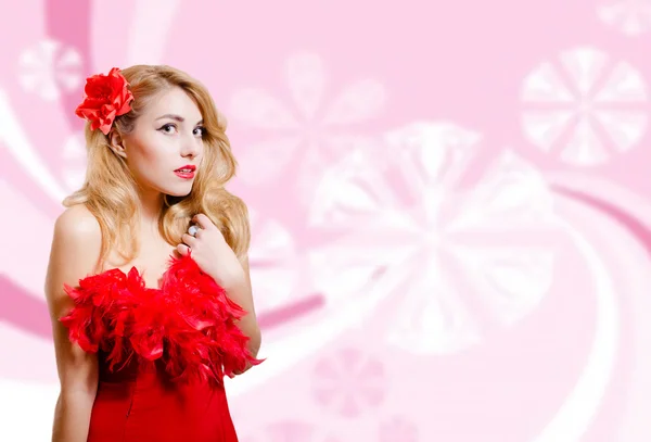 Pretty girl in red dress on blurred digital pink background — Stock fotografie