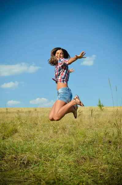 Tienermeisje springen op zomer veld — Stockfoto