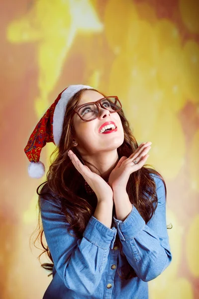 Funny hipster girl in supersize eyeglasses wearing xmas santa hat — Zdjęcie stockowe