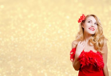 Pretty girl in red dress excited on bokeh lights background