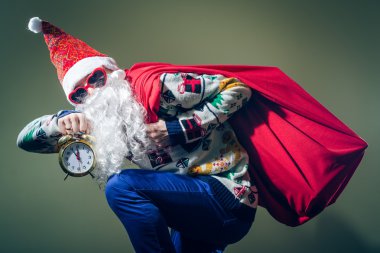 Funky Santa Claus with alarm clock wearing heart shape sunglasses 