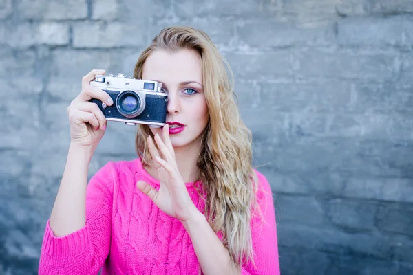 Happy young female taking photo on retro vintage hipster camera — Stock Fotó