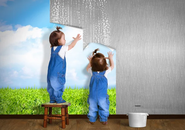 Pequenos gêmeos fazendo reparação em casa, pendurado papel de parede — Fotografia de Stock