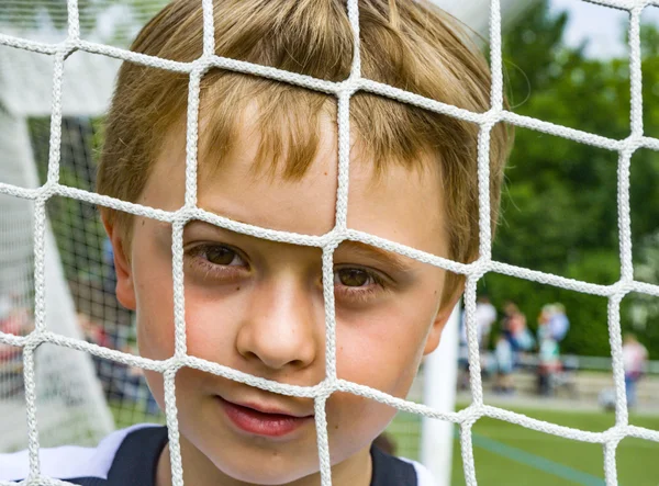 Jonge jongen speelt voetbal — Stockfoto