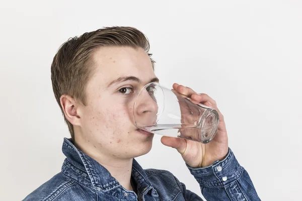 Portrait of cute teenage boy drinking water — Stock Photo, Image