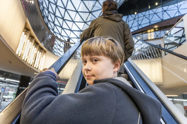 Child on moving staircase — Stock Photo, Image