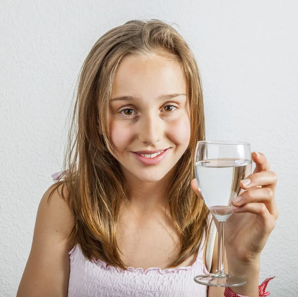 Portrait of young teenage girl drinking out of a glass — Stock Photo, Image