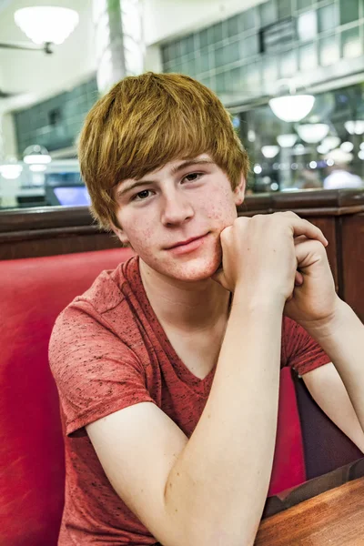 Smiling boy in a diners at night — Stock Photo, Image