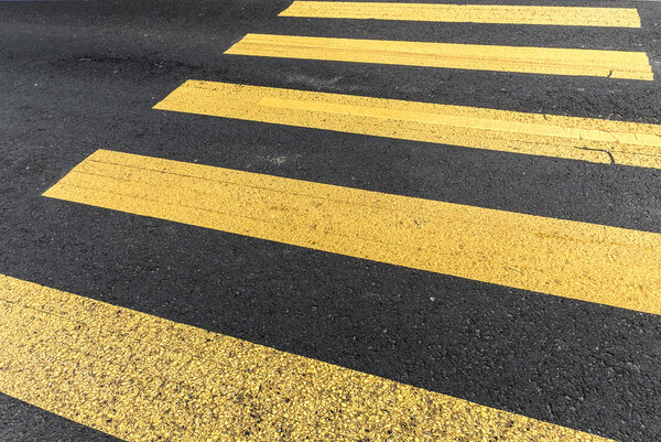 pederastian crossing in asphalt street and abstract background