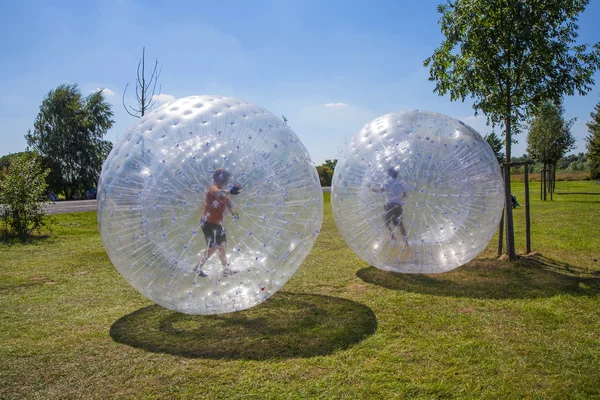 Barnen har roligt på zorbing bollen — Stockfoto