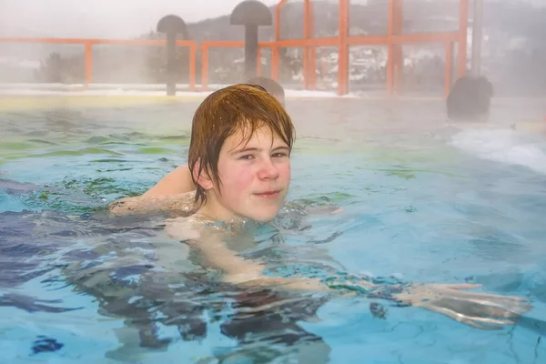 Young Boy Swims Hot Foggy Outdoor Pool Spa — Stock Photo, Image