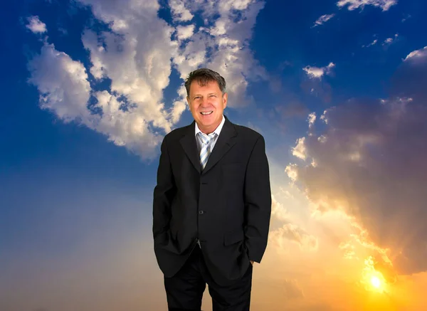Portrait of Handsome businessman on dramatic scenic sky background