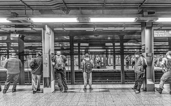 NEW YORK, USA - OCT 20, 2015: People wait at subway station Wall street in New York. With 1.75 billion annual ridership, NYC Subway is the 7th busiest metro system in the world.
