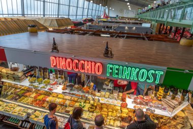 Frankfurt, Germany - August 28, 2021: people enjoy shopping in the Kleinmarkthalle in Frankfurt, Germany. The hall from 1954 is the most famous fresh food market in Frankfurt on 1500 SQ (m2). clipart