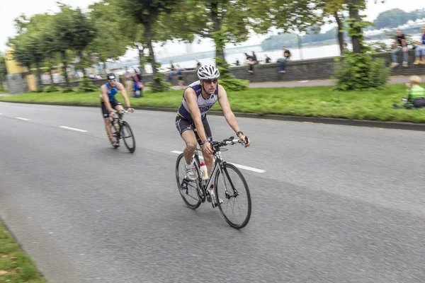 An athlete cycles in the Cologne Triathlon — Stock Photo, Image