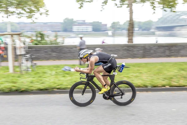 An athlete cycles in the Cologne Triathlon — Stock Photo, Image