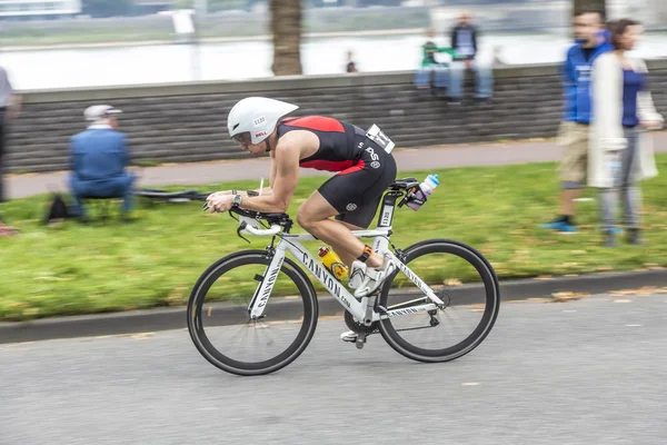 An athlete cycles in the Cologne Triathlon — Stock Photo, Image