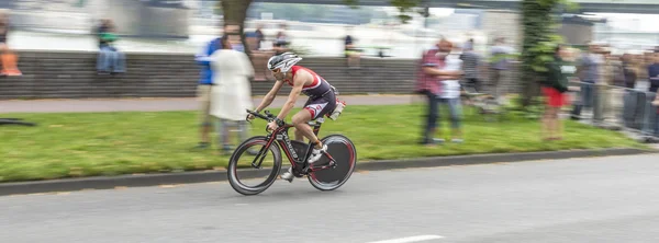 An athlete cycles in the Cologne Triathlon — Stock Photo, Image