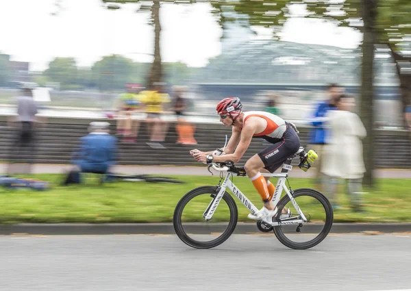 An athlete cycles in the Cologne Triathlon — Stock Photo, Image