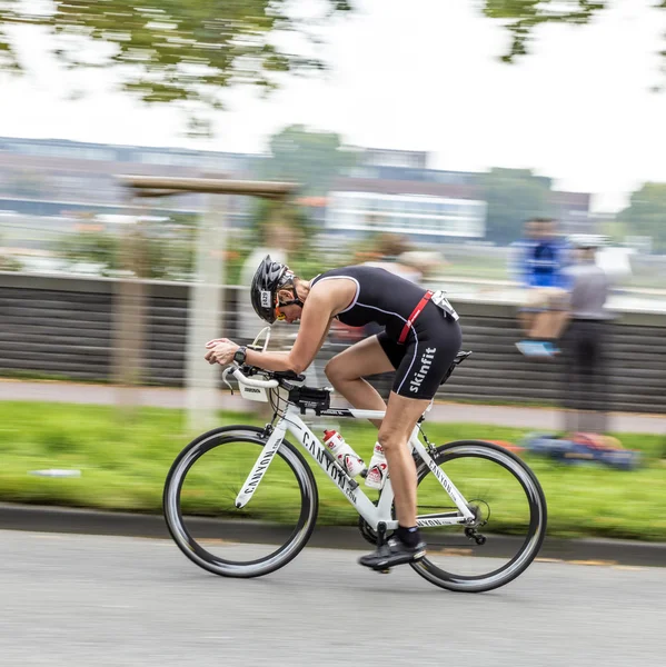 An athlete cycles in the Cologne Triathlon — Stock Photo, Image