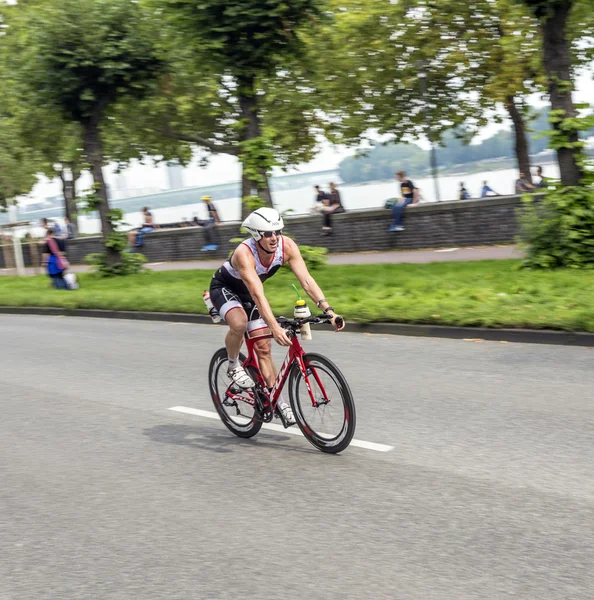 An athlete cycles in the Cologne Triathlon Stock Picture