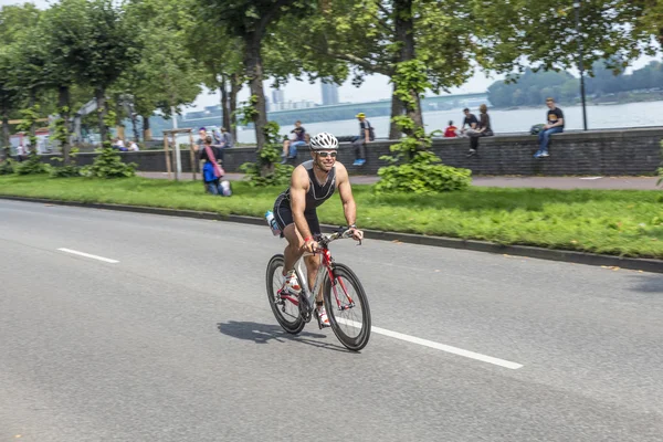 An athlete cycles in the Cologne Triathlon — Stock Photo, Image