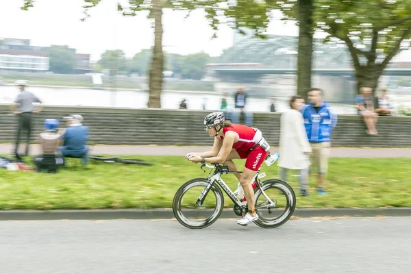 An athlete cycles in the Cologne Triathlon — Stock Photo, Image