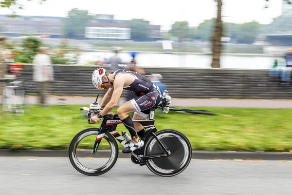 An athlete cycles in the Cologne Triathlon — Stock Photo, Image