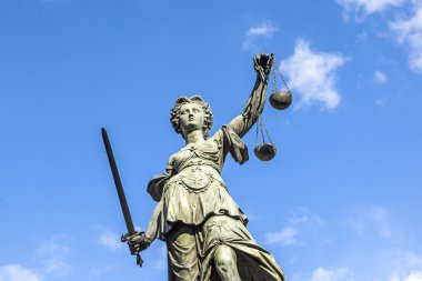 Justitia (Lady Justice) sculpture on the Roemerberg square in Fr clipart