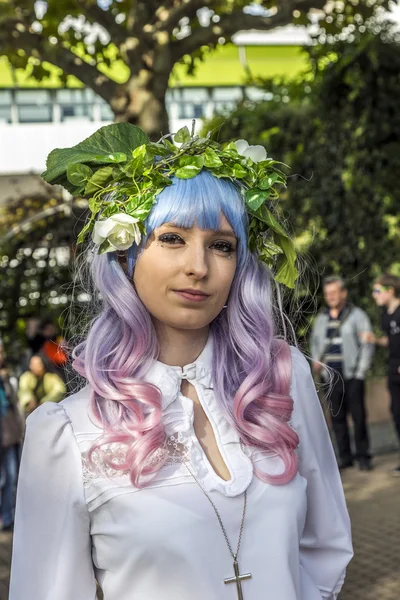 Colorful girl made up as Manga girl and poses for photographers — Stock Photo, Image