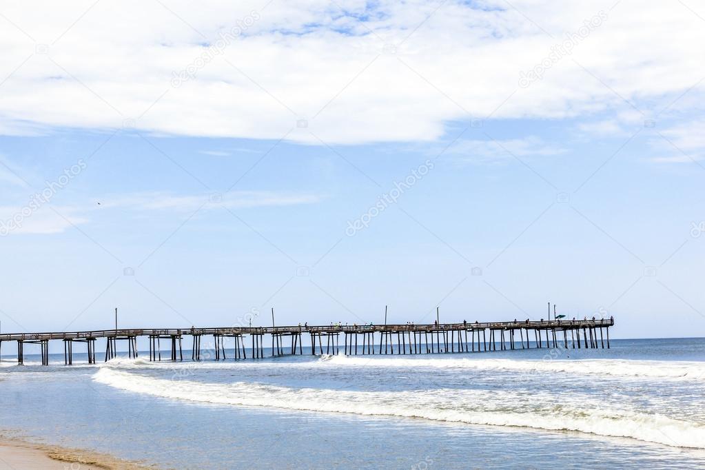 beach with old wooden pier