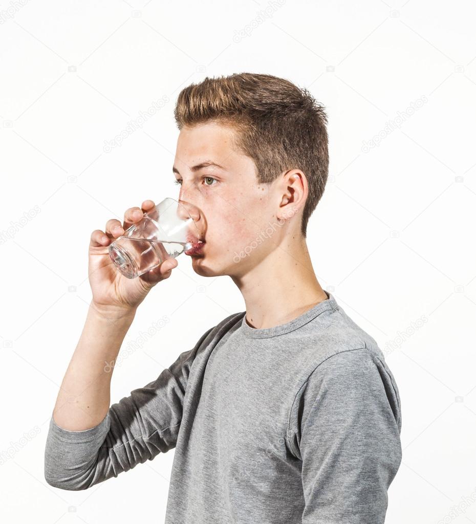 attractive  caucasian teenage boy drinking water